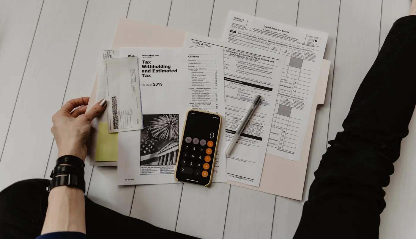 Payroll paperwork and calculator on a desk